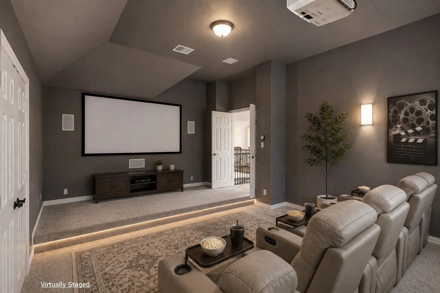 Dedicated media room with tiered seating, wall-mounted speakers, recessed lighting, and a large projection screen