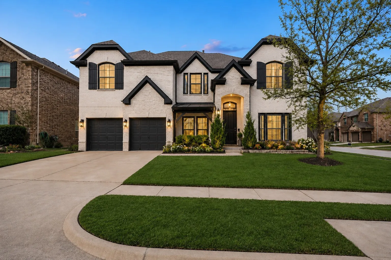 Two-story brick exterior with black shutters and trim accents
