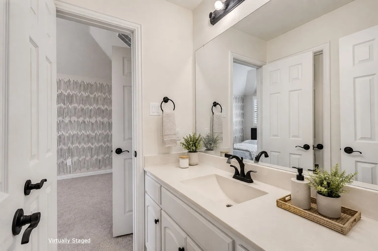 White vanity with an integrated rectangular sink and matte black faucet
