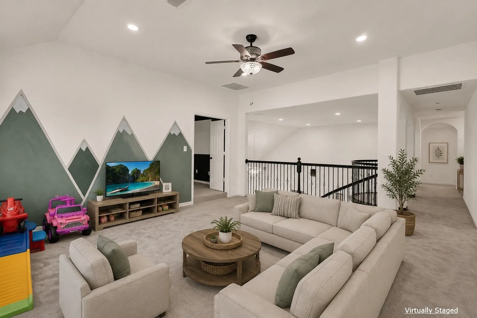 Spacious loft area featuring a ceiling fan with light fixture, recessed lighting, and a decorative wall accent