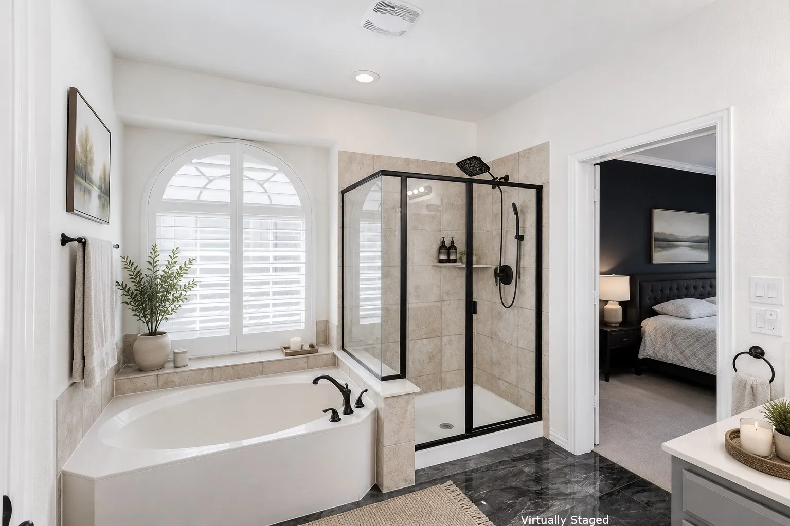 Soaking tub with arched window and plantation shutters