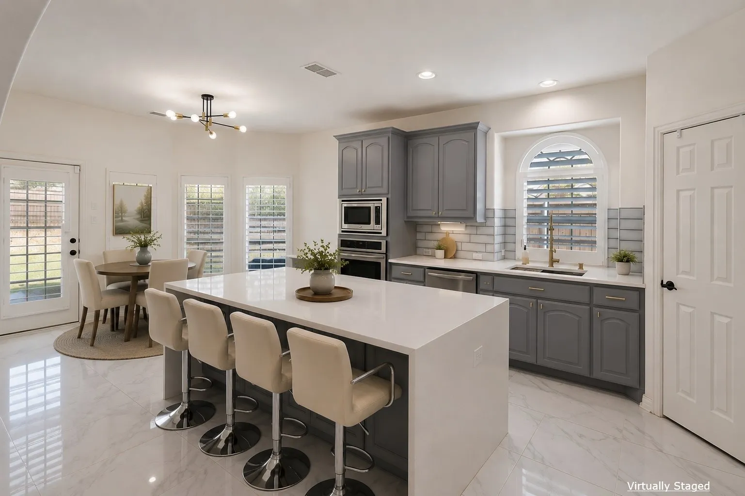 Modern kitchen featuring grey cabinetry, stainless steel appliances, a large center island with a white countertop, and tile flooring