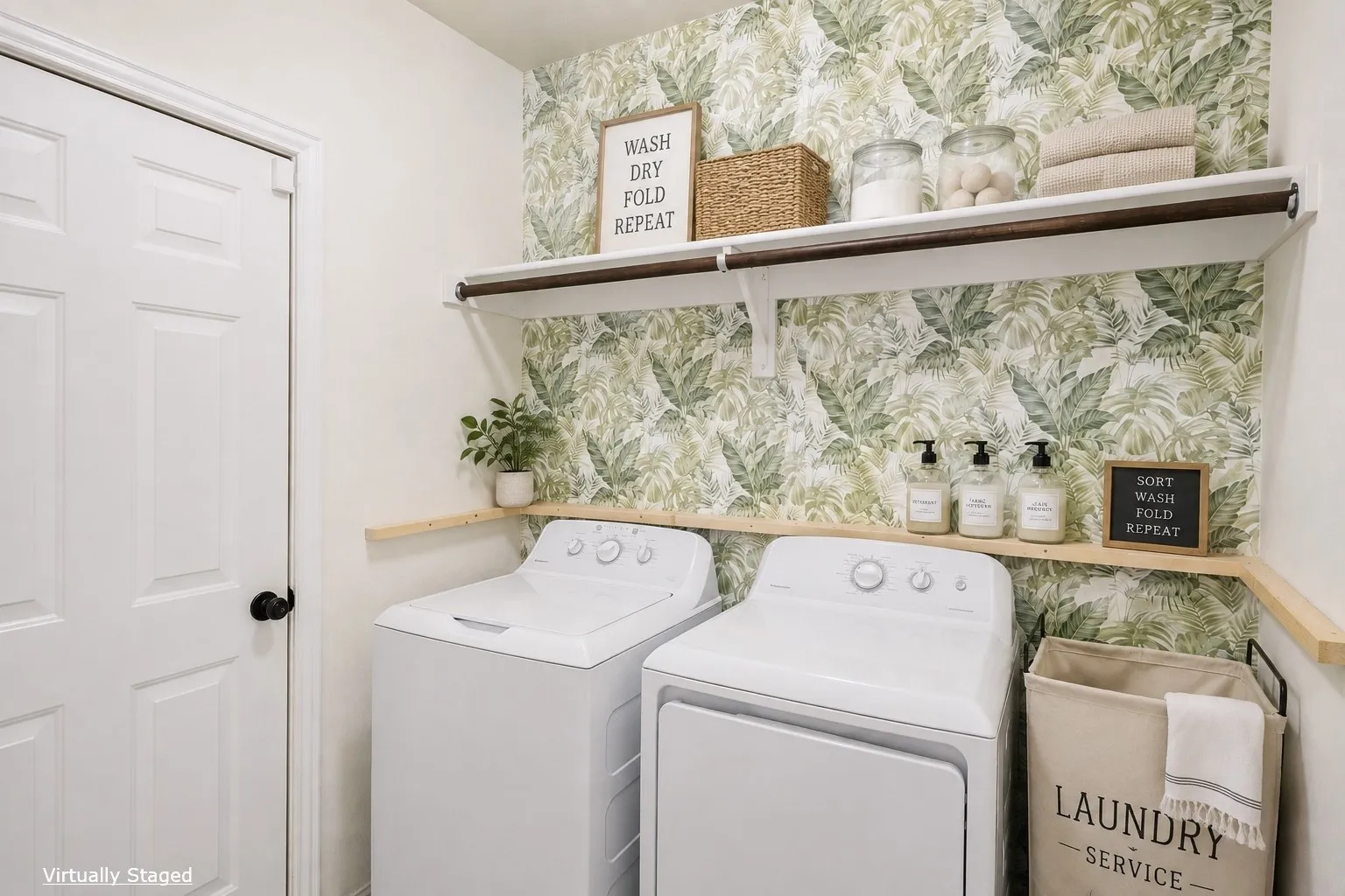 Laundry area featuring a paneled door with black hardware, a light-toned wall finish, and a wood-finish wall shelf