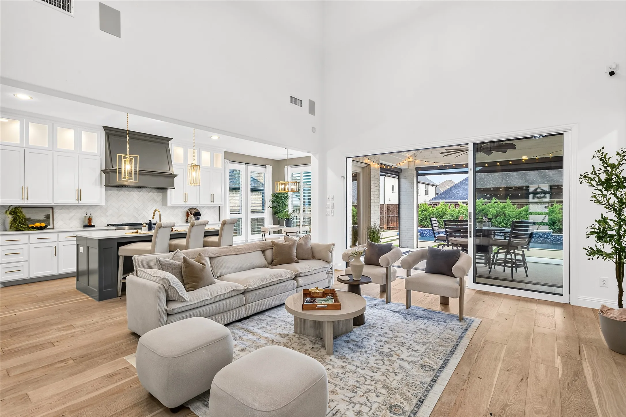 Soaring ceilings and a full wall of sliding glass doors flood the great room with natural light.