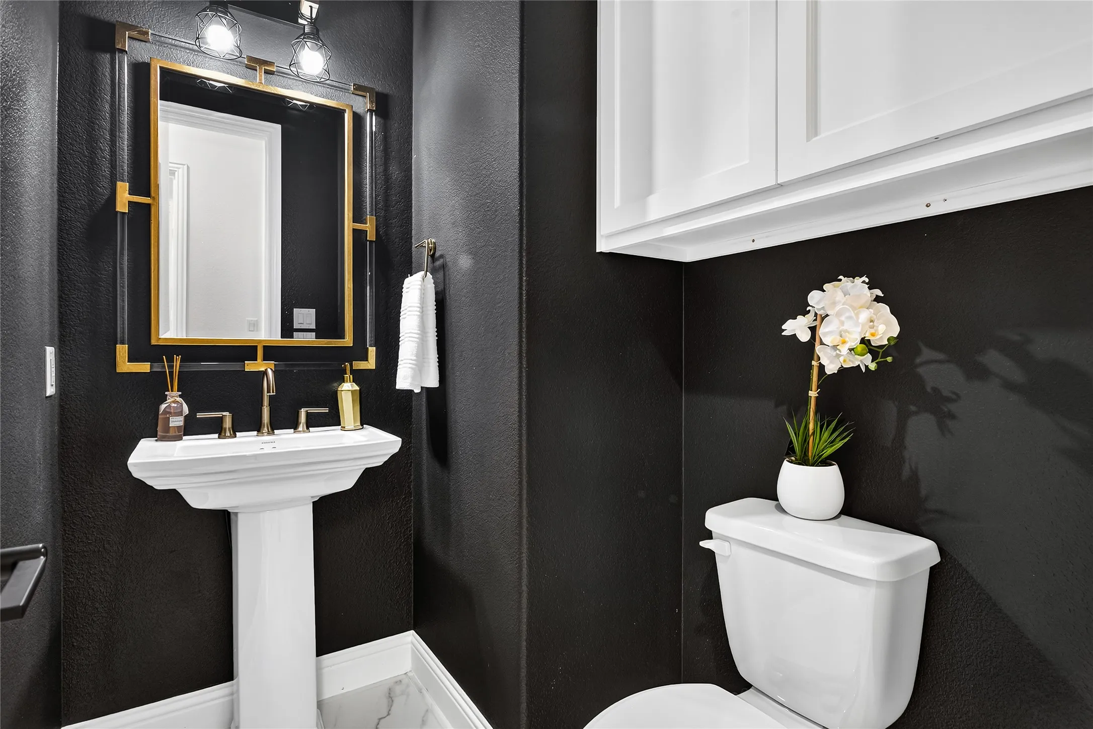 Elegant powder bath accessible but separated from entertaining spaces.