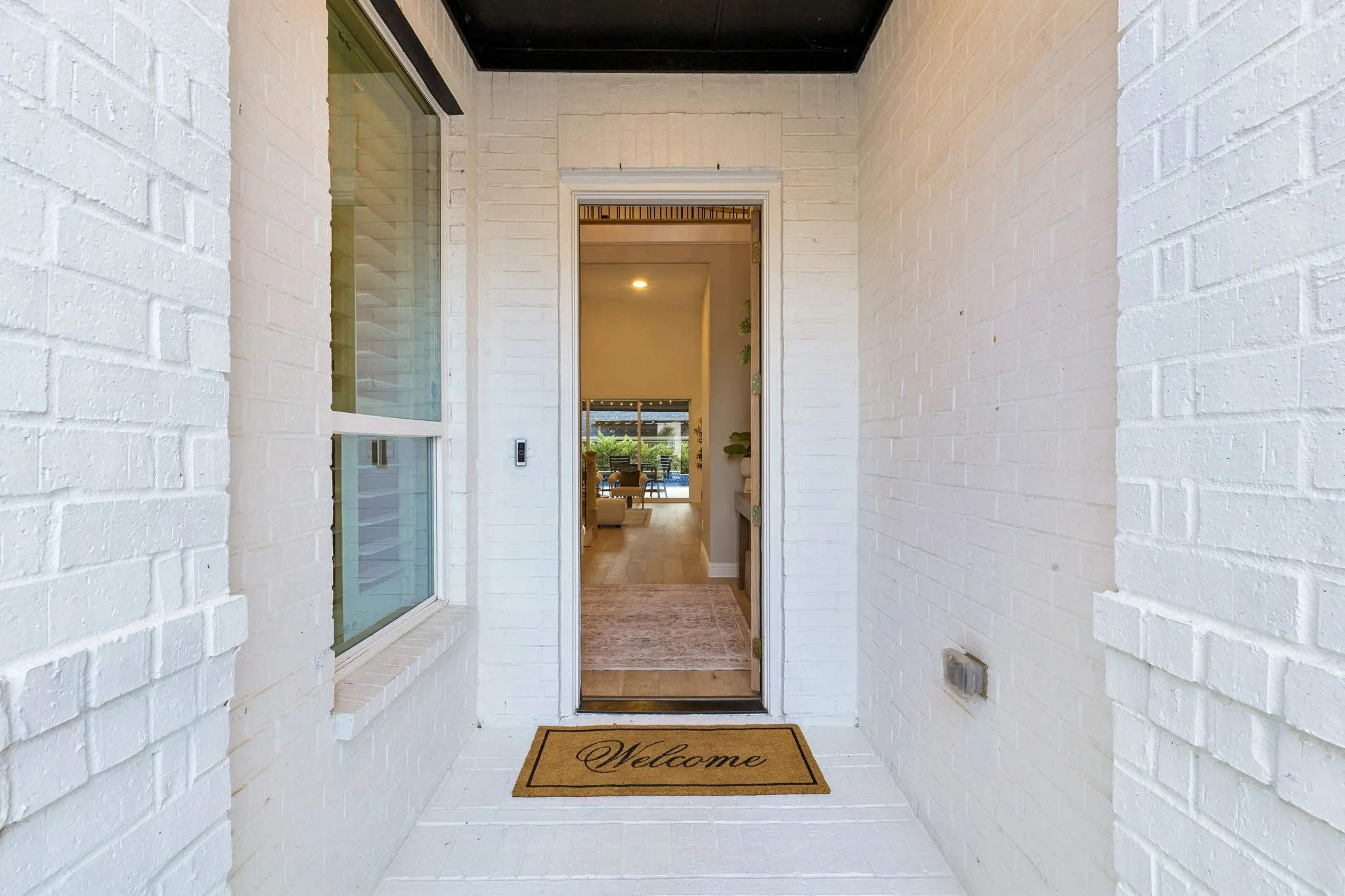 Entryway with uninterrupted views from the front door to the pool.