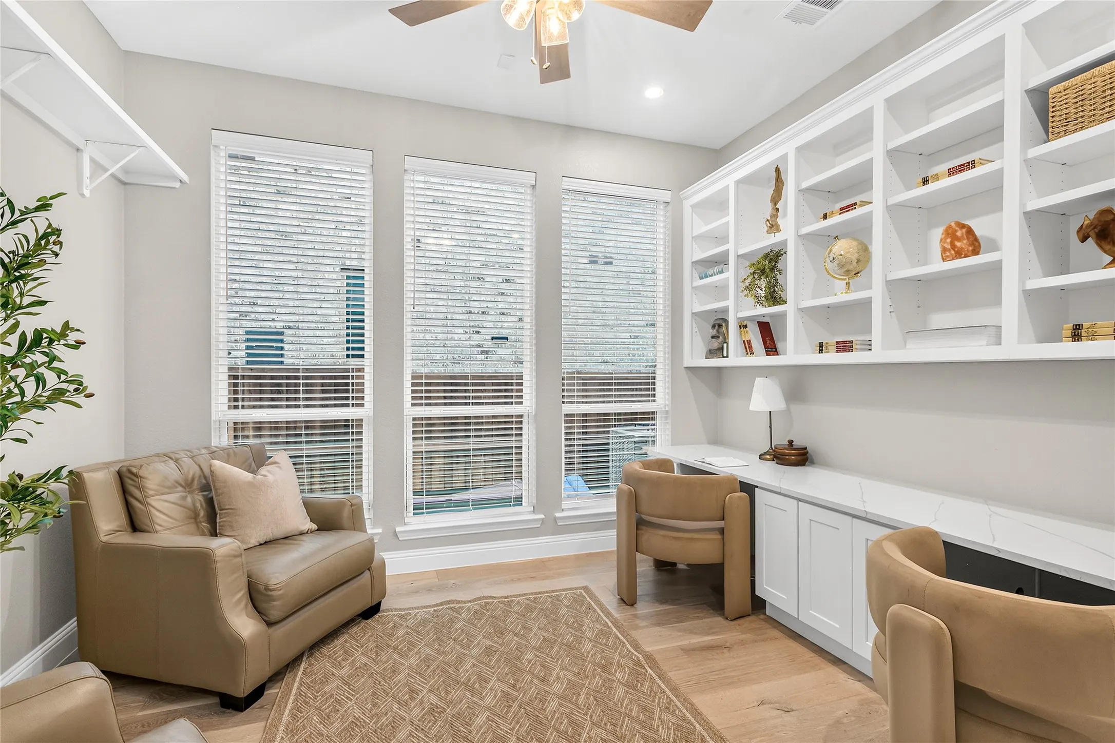 Private home office with custom built-in shelving is ideal for remote work