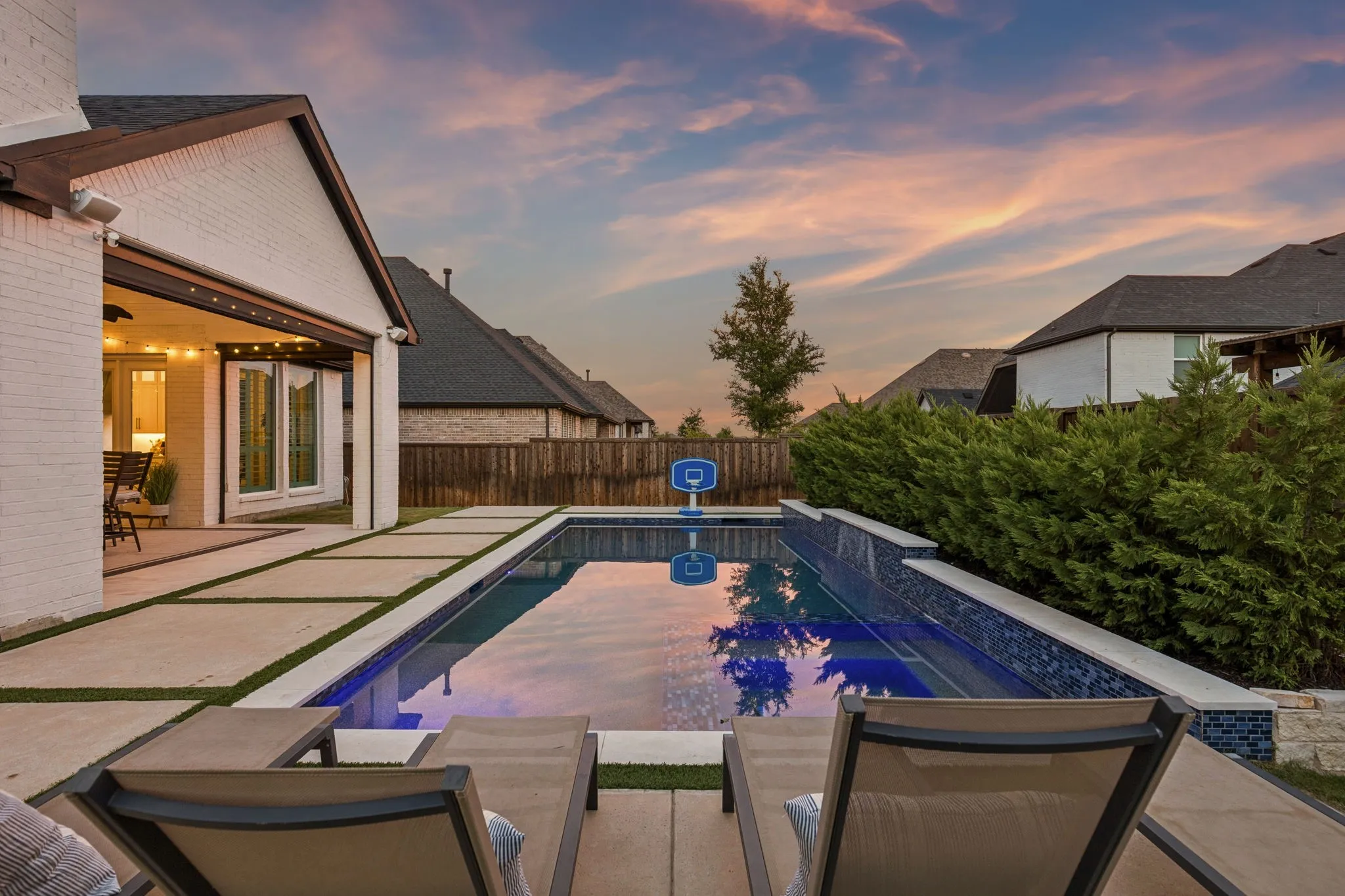 Twilight views of the heated, shallow chlorine pool — a perfect setting for relaxed gatherings.