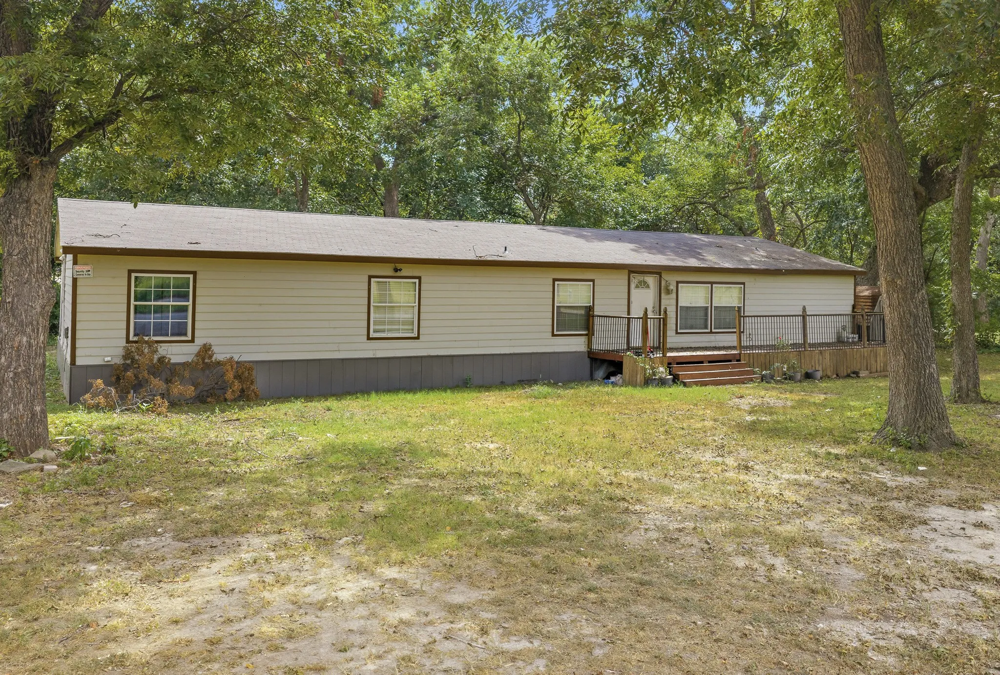 Light-colored siding exterior with a dark trim roofline