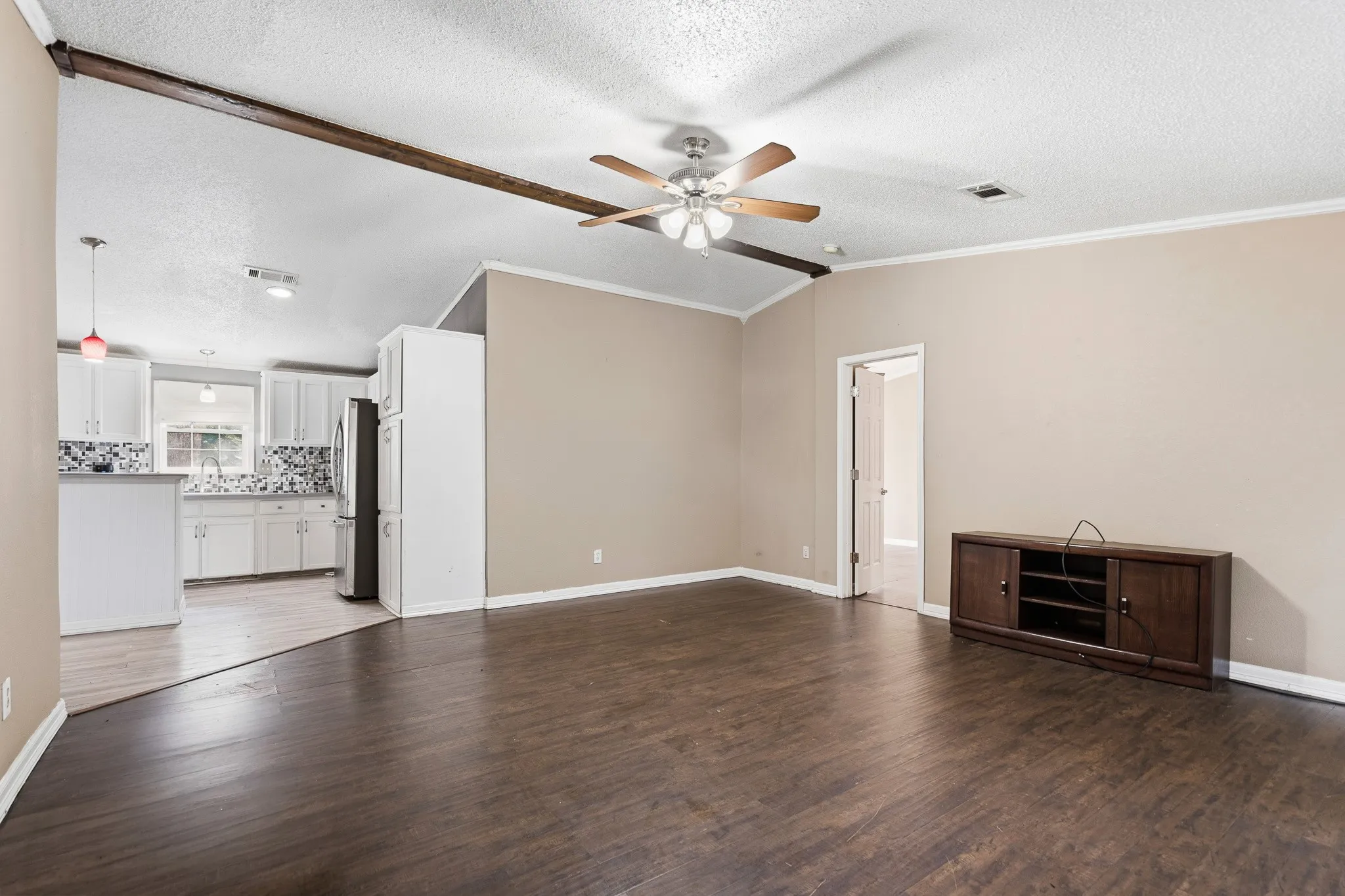 Wood-finish flooring, ceiling fan, and crown molding
