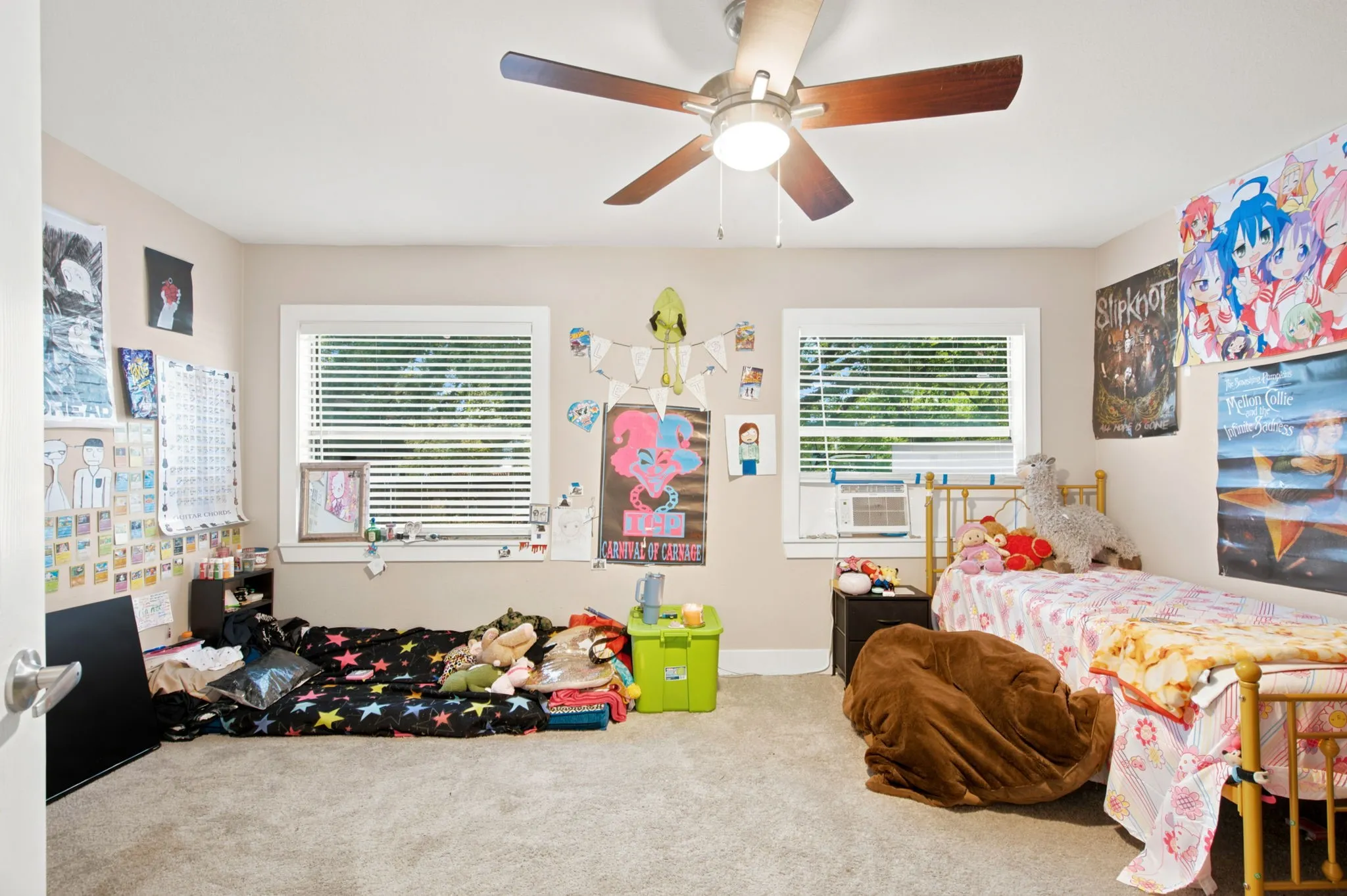 Textured carpeting, white trim windows, and a ceiling fan with light fixture