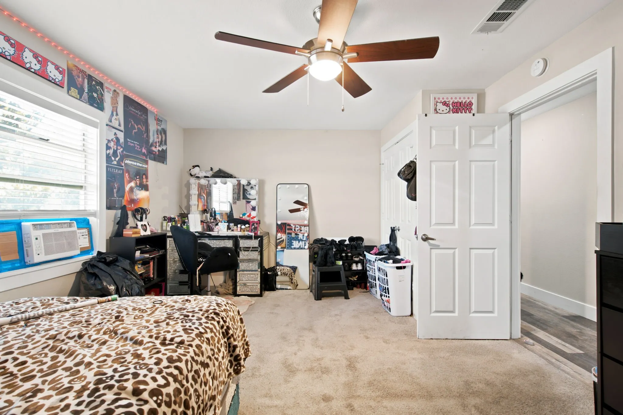 Wall-to-wall carpeting and a ceiling fan with integrated lighting
