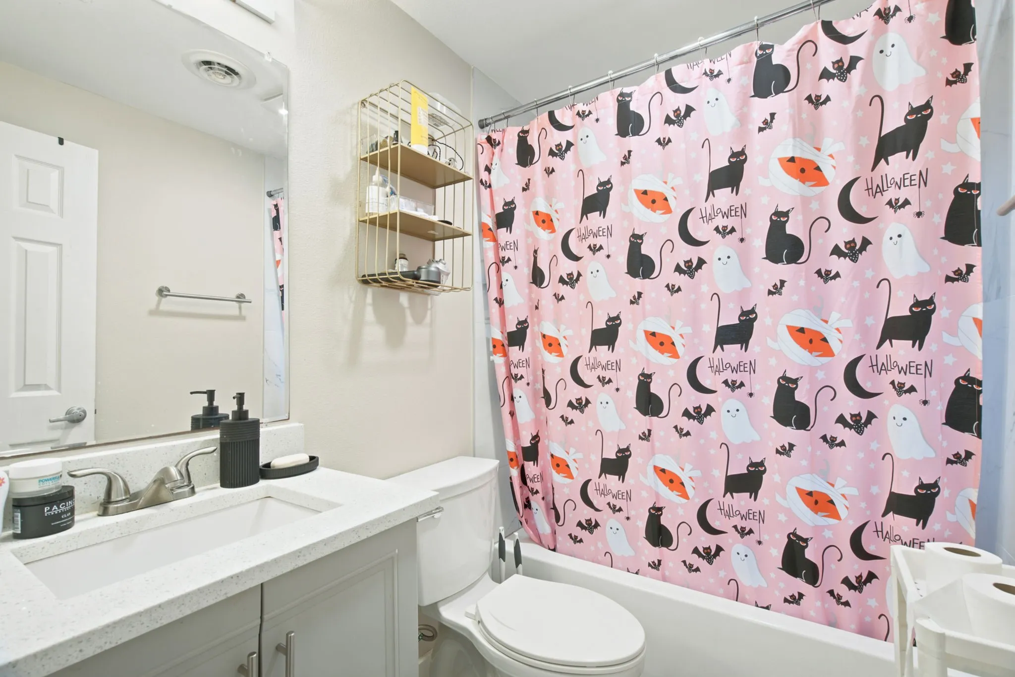 White vanity with an integrated rectangular sink, wall-mounted mirror, and a built-in bathtub