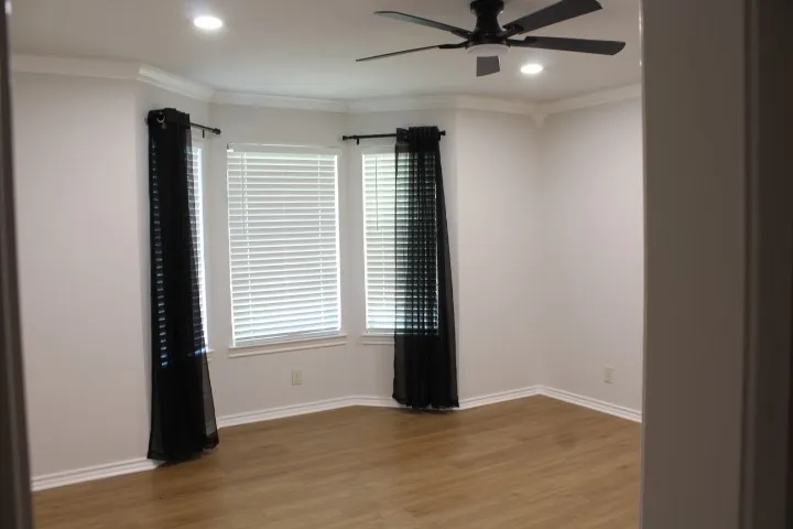 Four Bedroom with  wood-finish flooring, recessed lighting, ceiling fan, and crown molding