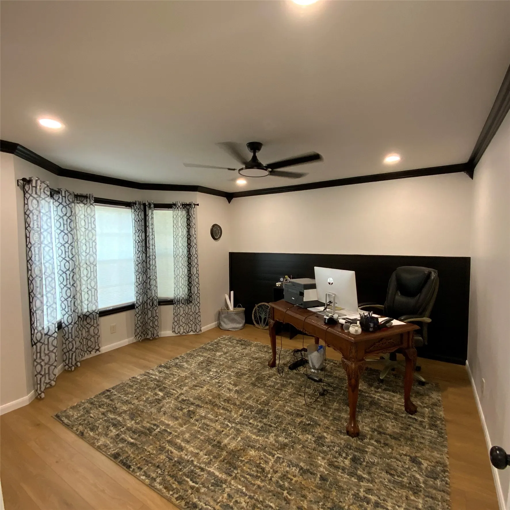 Recessed lighting, crown molding, ceiling fan, wood-finish flooring, and bay windows