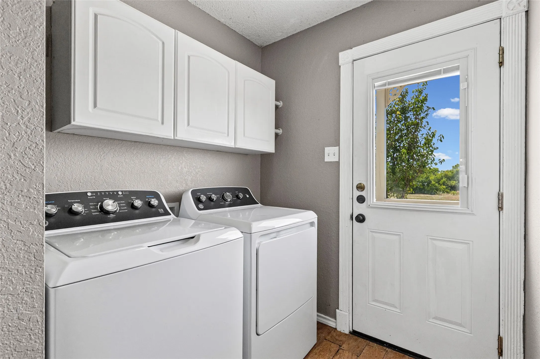 White overhead cabinetry with arched panel doors