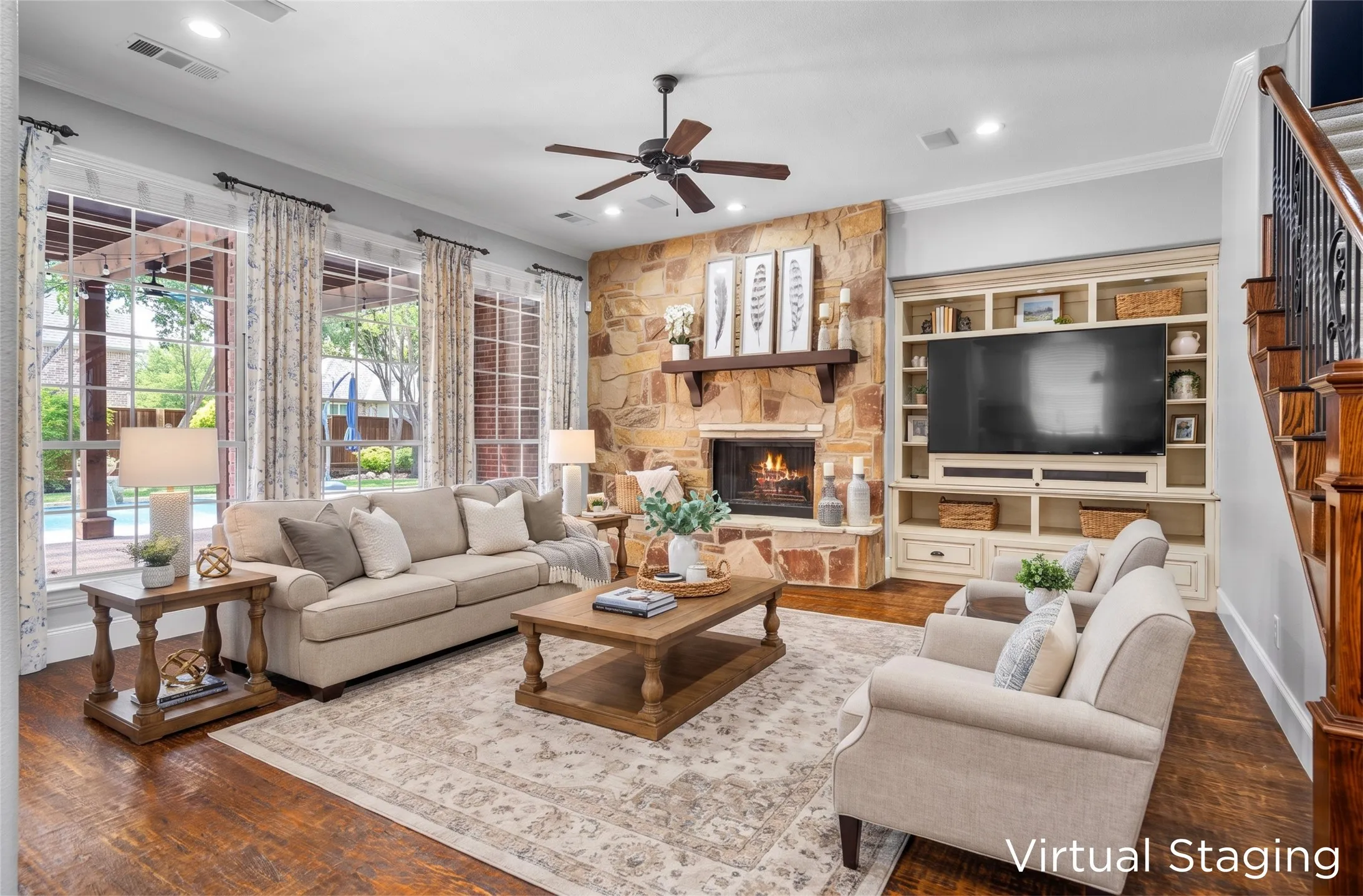 Cozy living room with stacked-stone fireplace, custom built-ins & French doors to the backyard