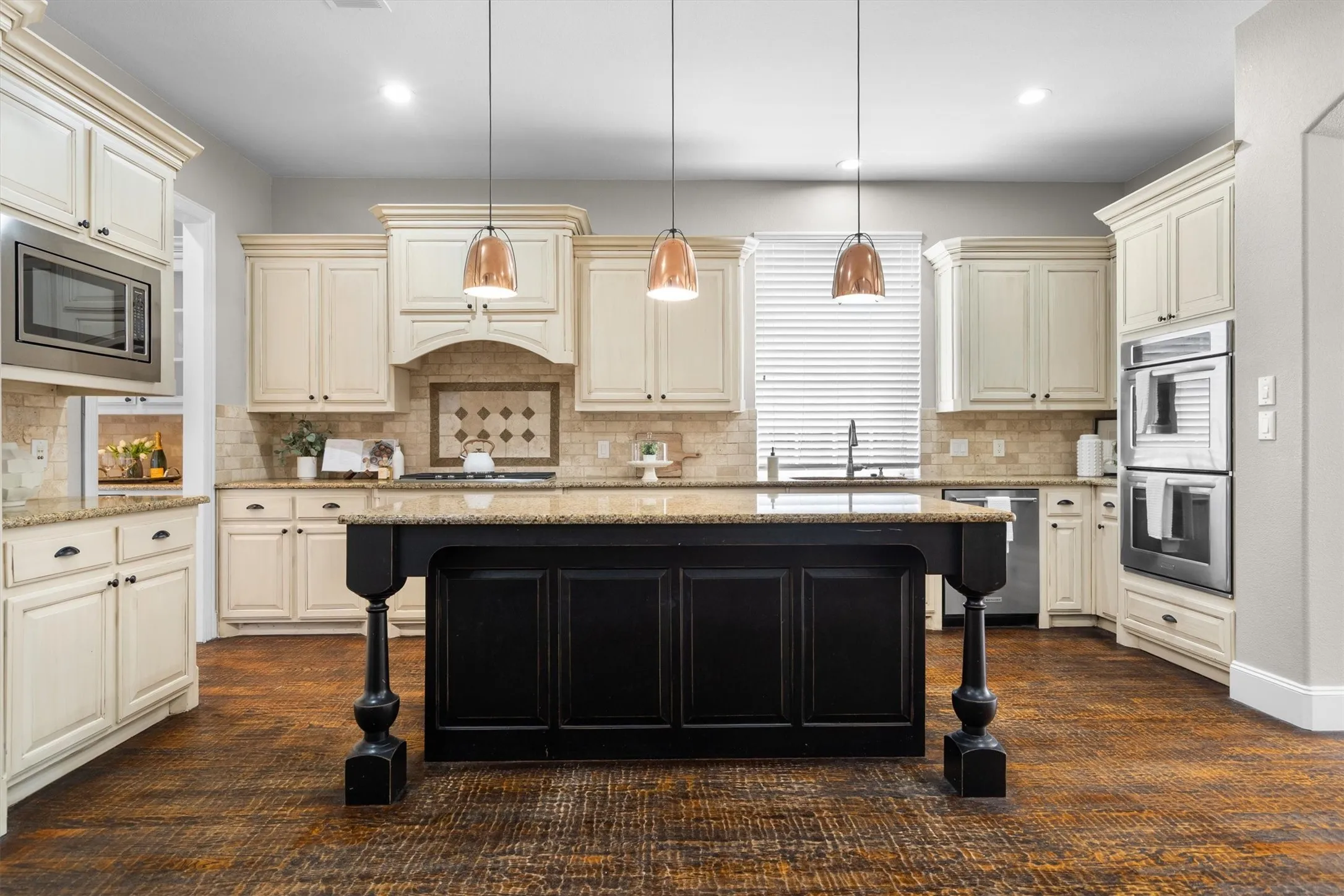 Chef's kitchen featuring center island, pendant lighting & abundant counter space
