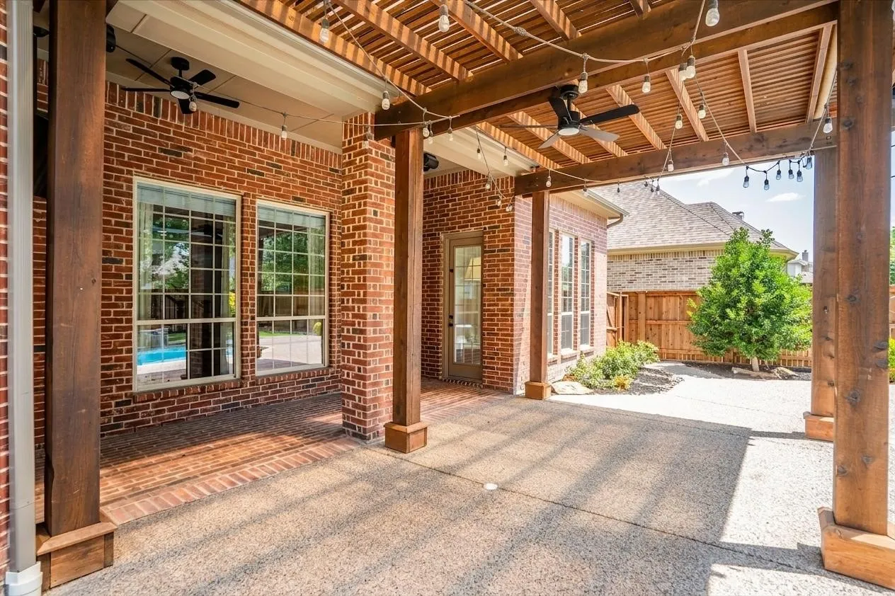Covered patio/pergola overlooking the sparkling backyard pool