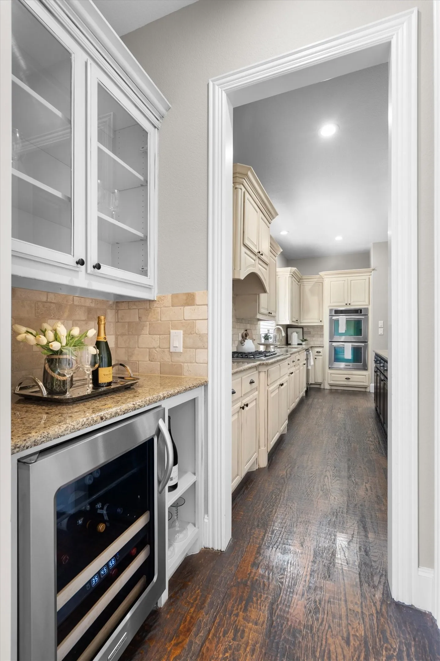 Butler's pantry/wine bar area with built-in wine fridge and extra cabinetry