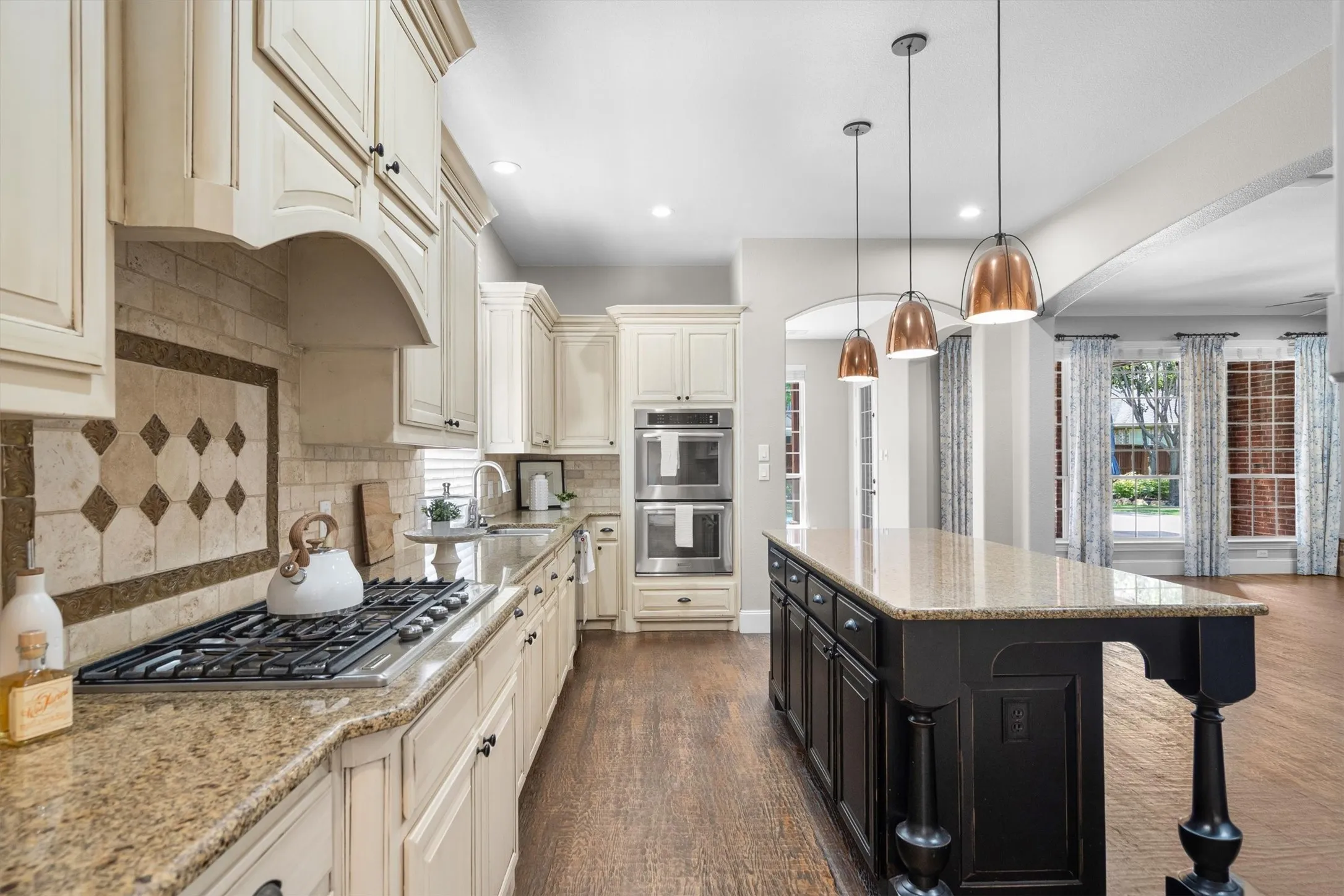 Wide kitchen view showcasing oversized island and open flow to living areas