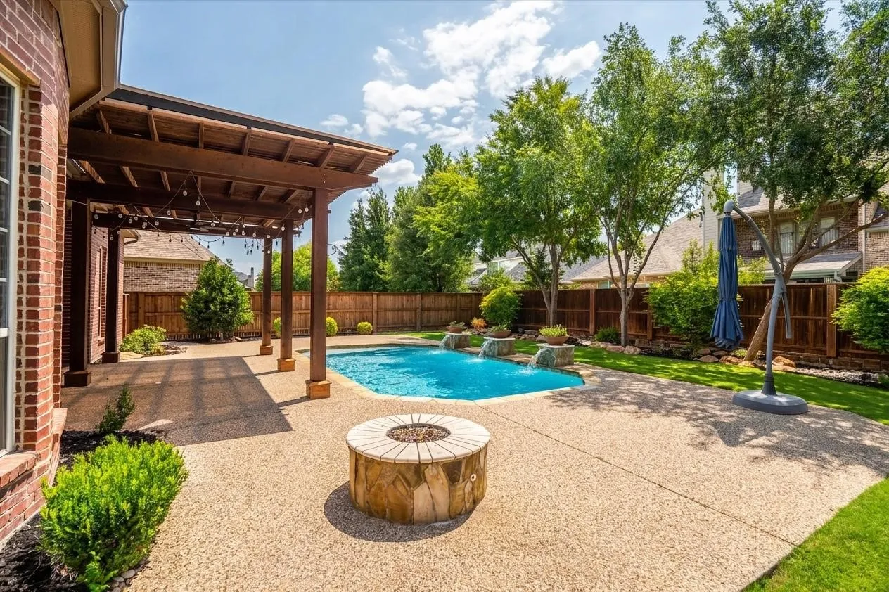 Resort-style pool with waterfall feature and lush landscaping
