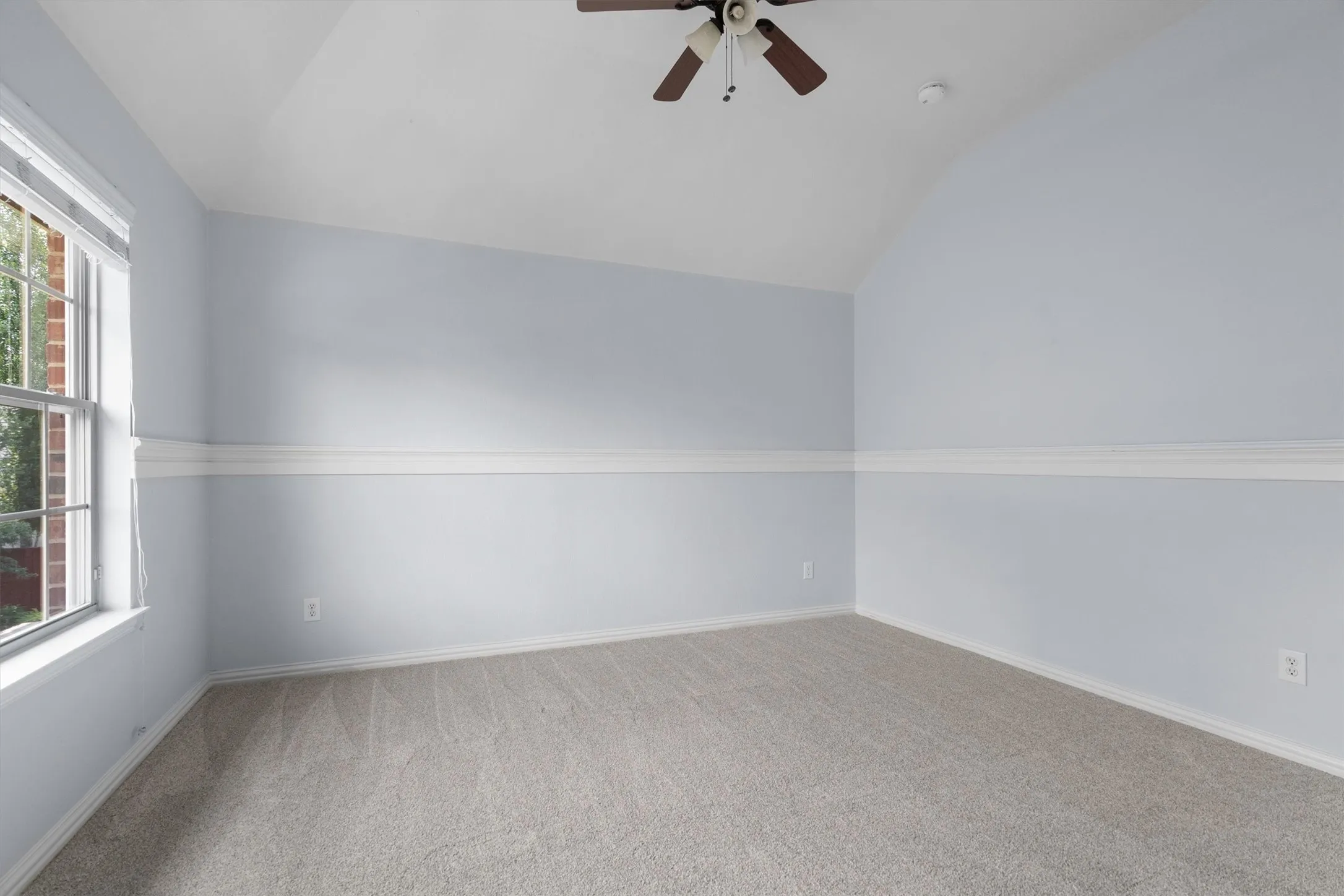 Third upstairs bedroom with vaulted ceiling and abundant natural light