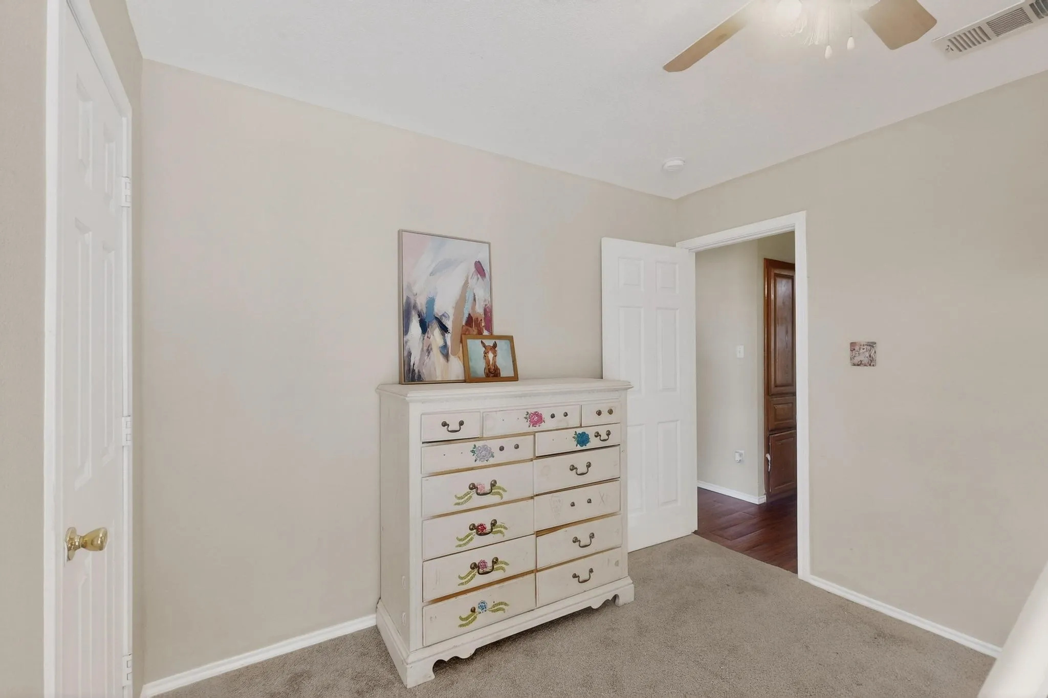 Neutral-toned walls complement plush carpeting