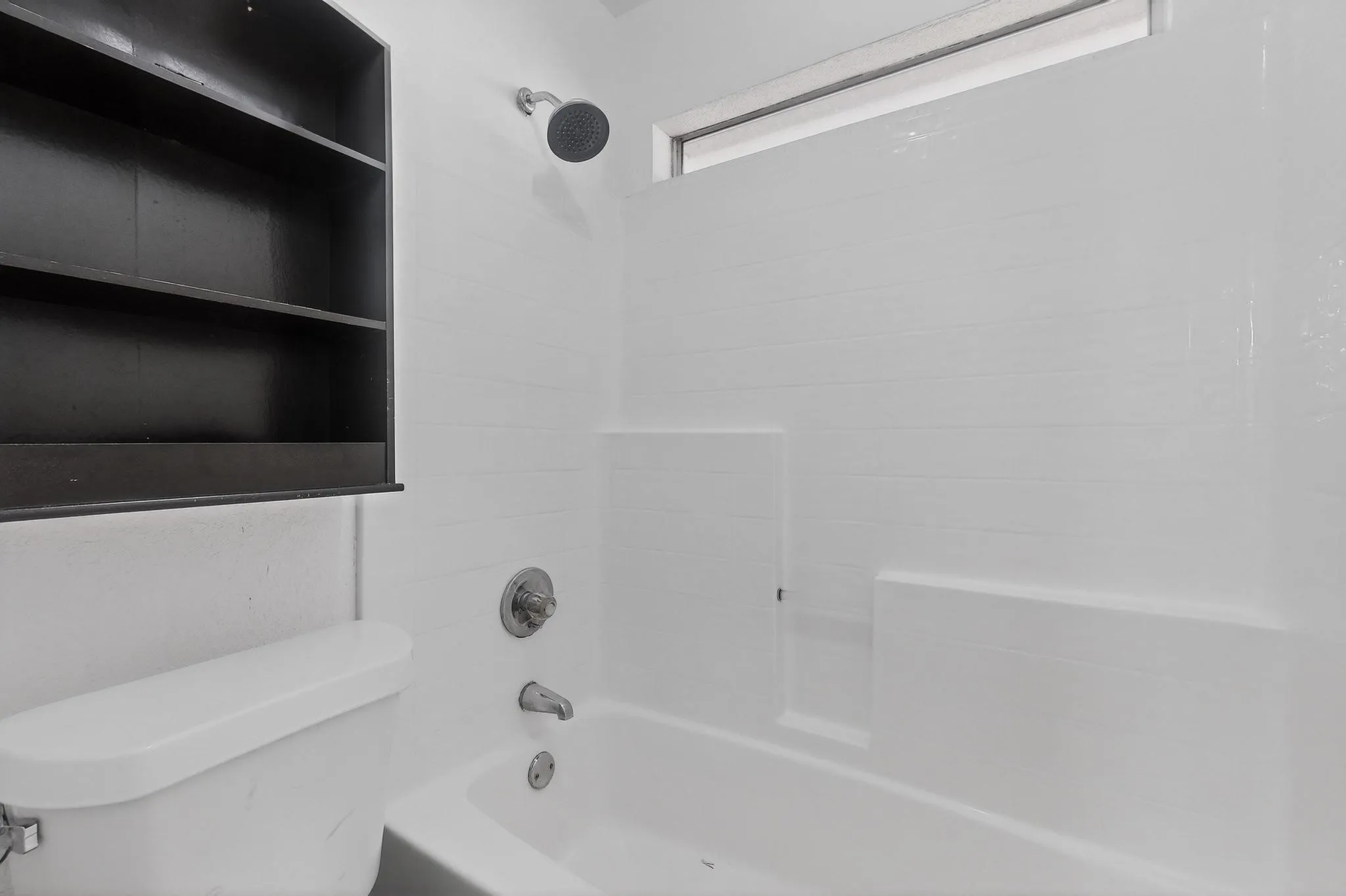 White bath and shower combination with a rainfall showerhead