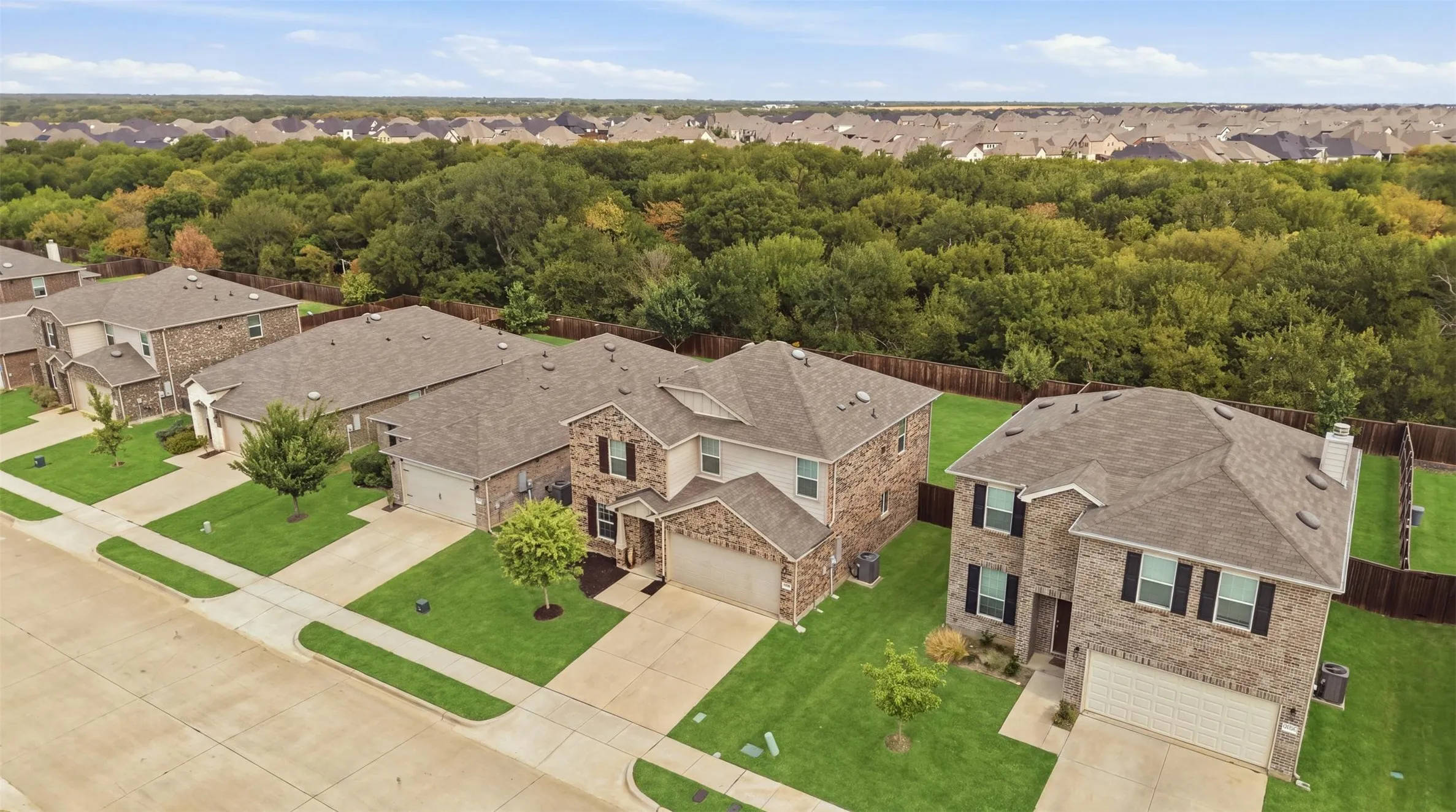 Charming two-story home with brick-and-siding exterior, attached garage, and a private fenced backyard