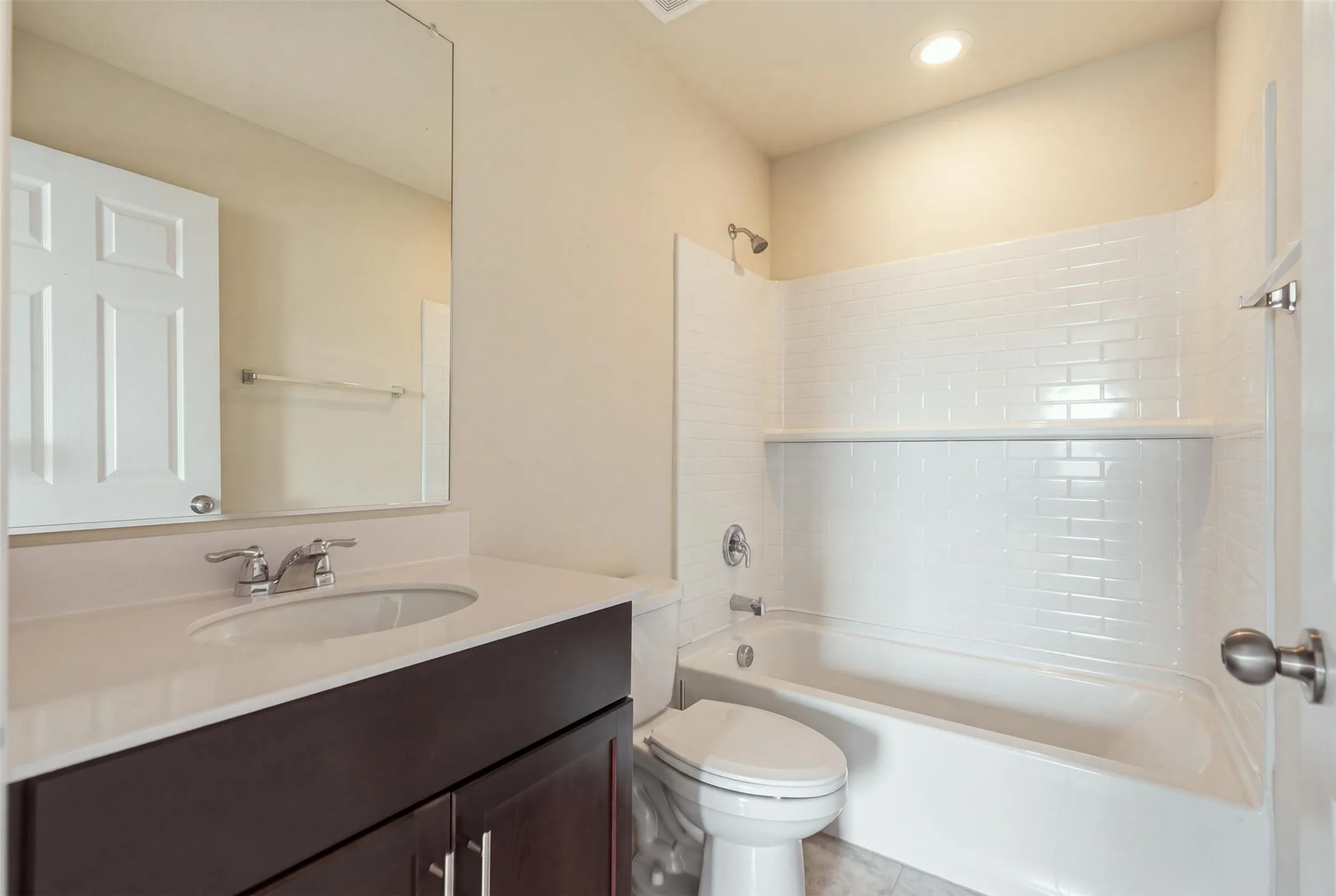 Bright white subway tile shower with a built-in shelf for a clean, functional finish
