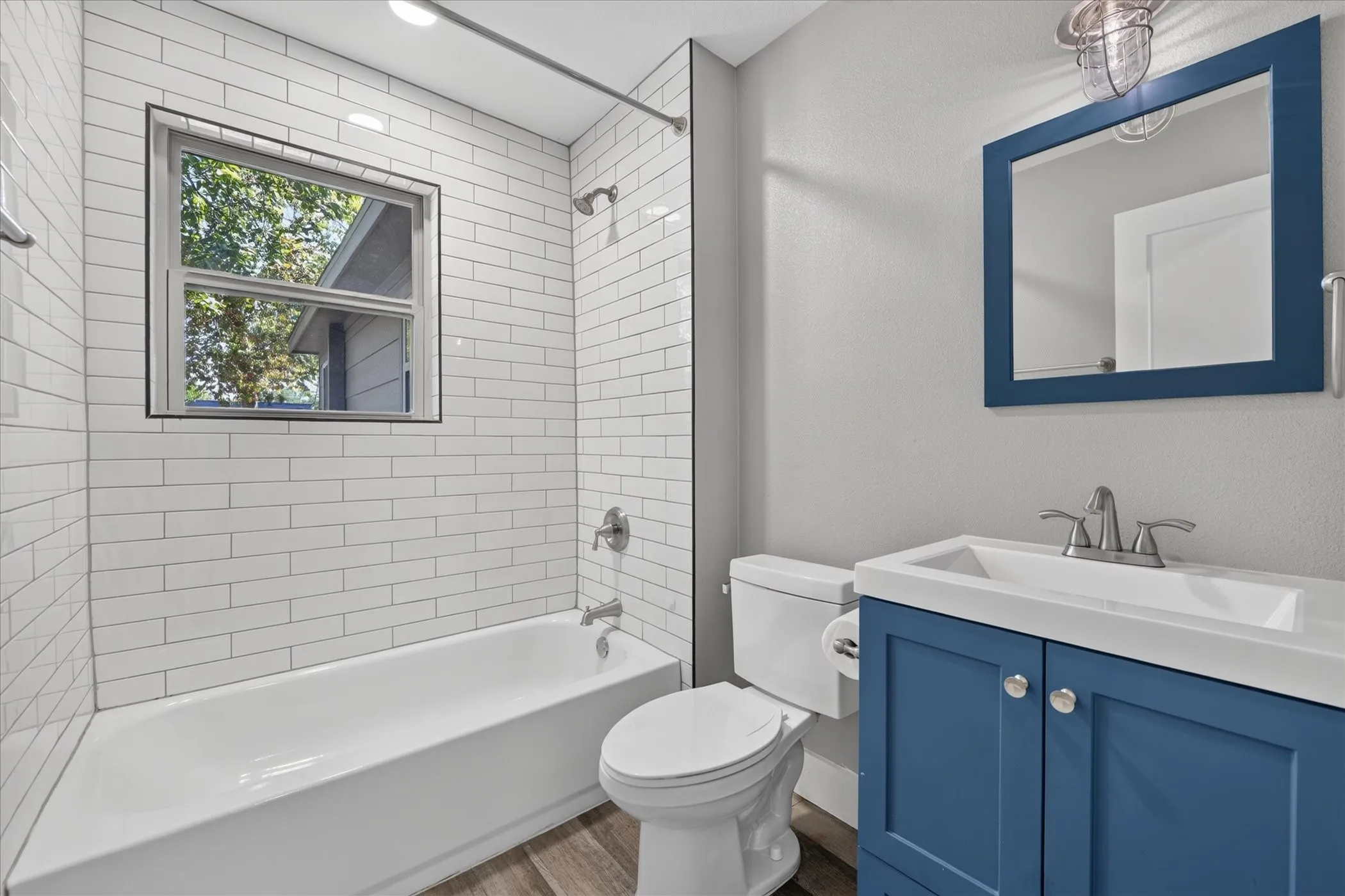 White subway tile shower surround with integrated window