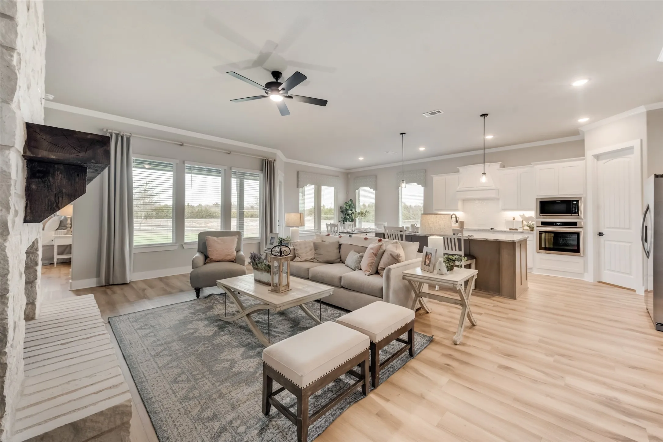 Light wood-finish flooring extends through the open-concept living area and kitchen