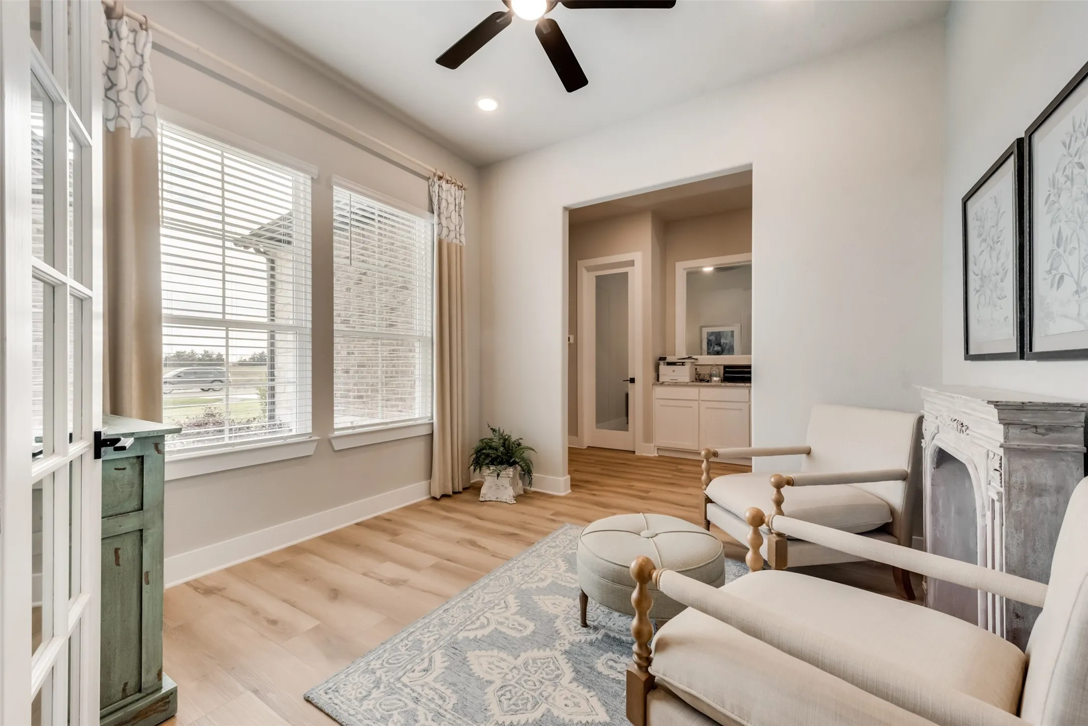 Recessed lighting, wood-finish flooring, ceiling fan, and multiple windows with blinds