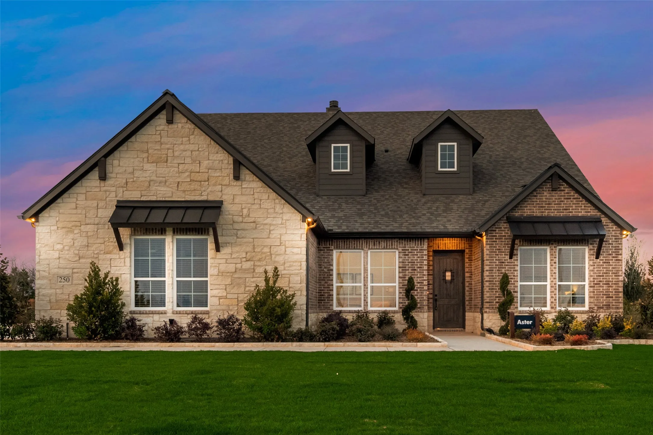 Stone and brick facade with dark window awnings