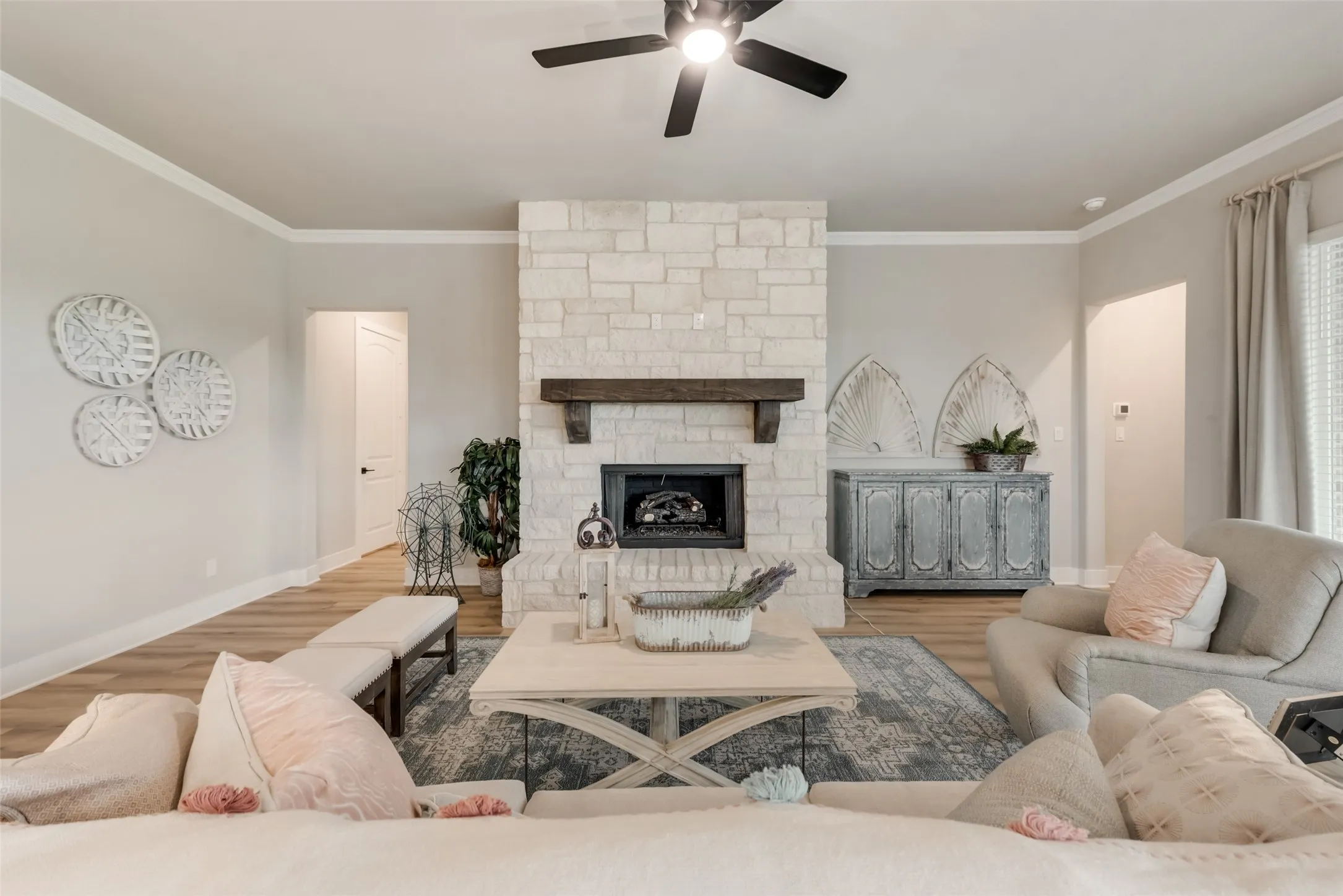 Stone-clad fireplace with a wood mantel