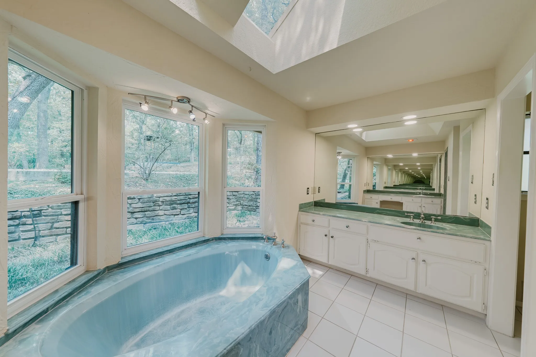 Skylight and multiple windows provide ample illumination, complemented by a track lighting fixture