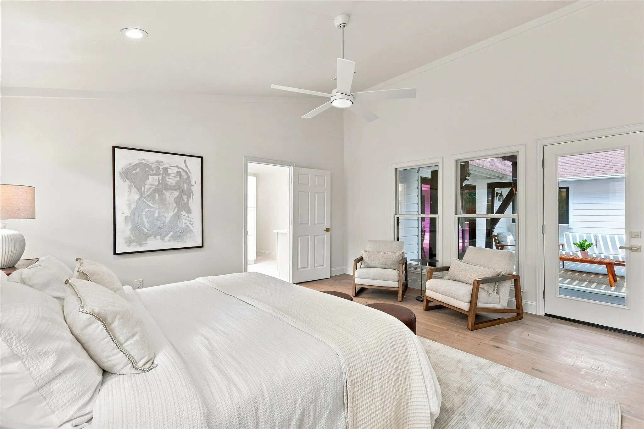 Vaulted ceiling with recessed lighting, wood-finish flooring, and a white ceiling fan