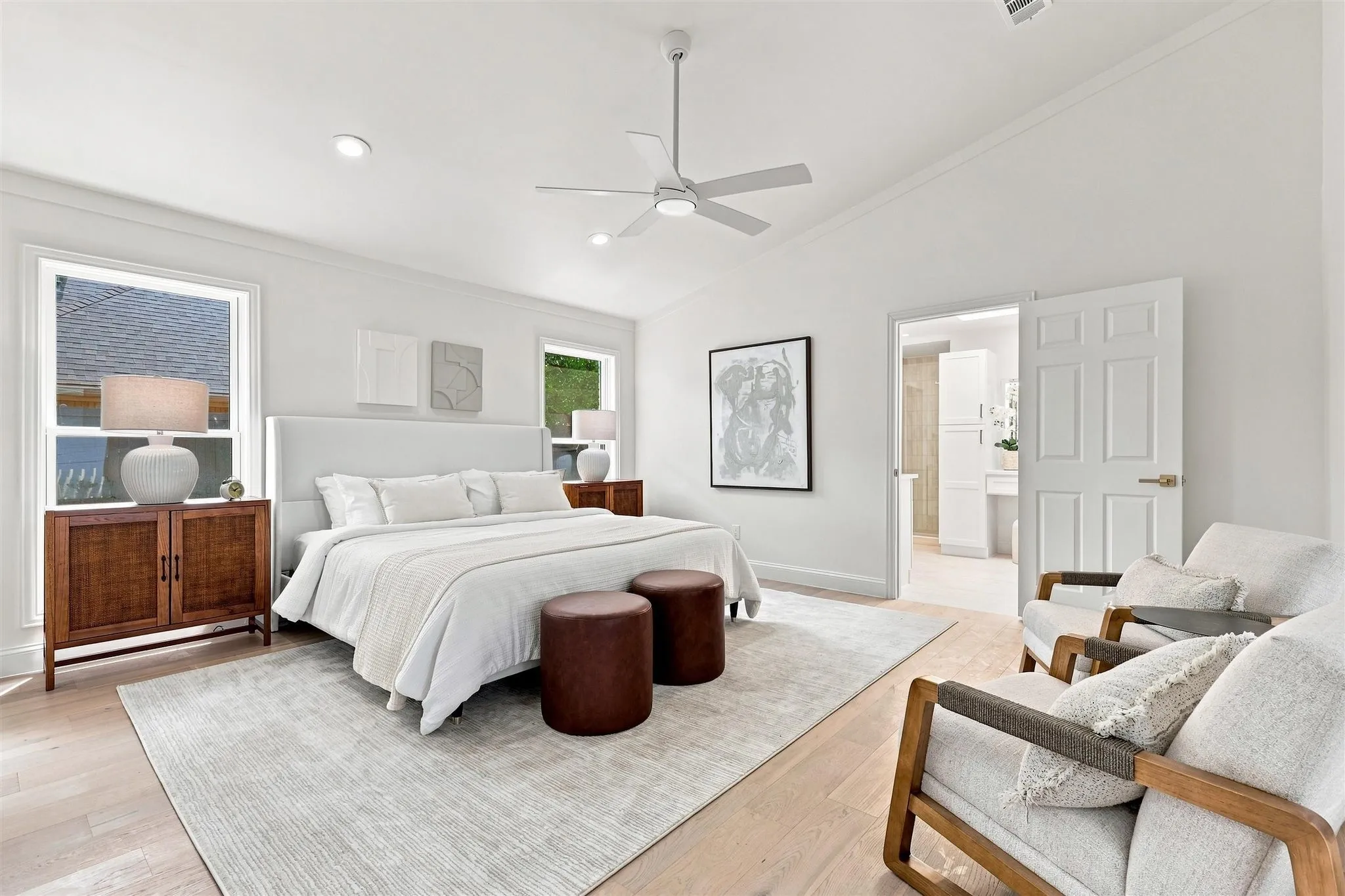Vaulted ceiling, recessed lighting, ceiling fan, wood-finish flooring, and white trim