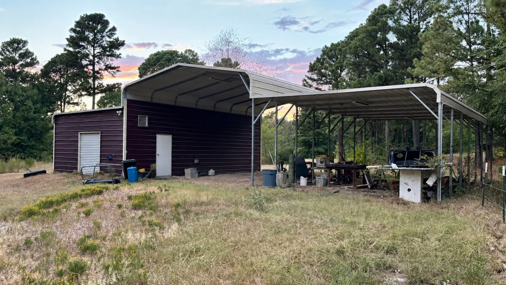 Storage Garage with RV and Boat Carport Behind Double-Wide Home.