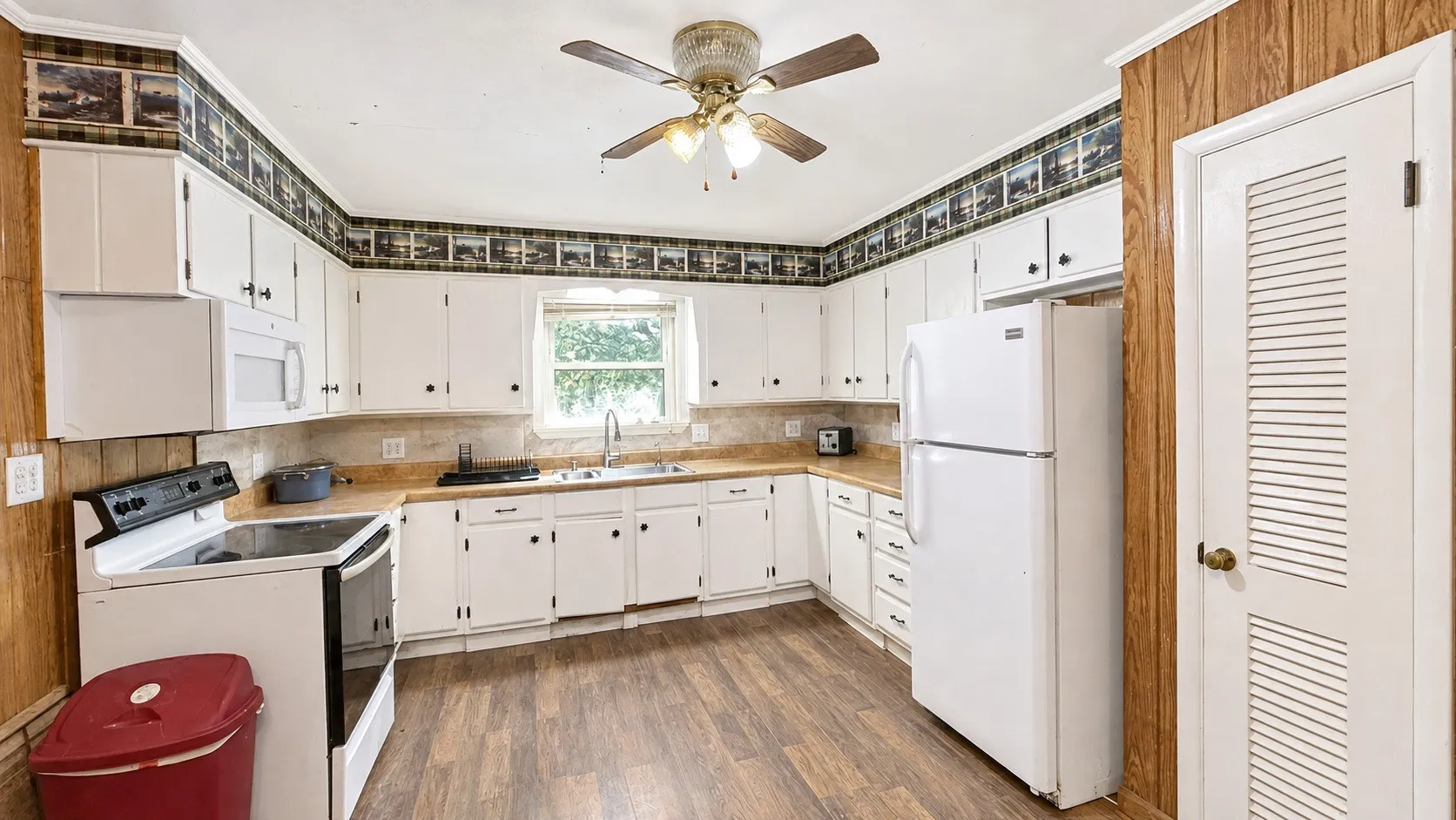Kitchen with Pantry in Red Brick Home.