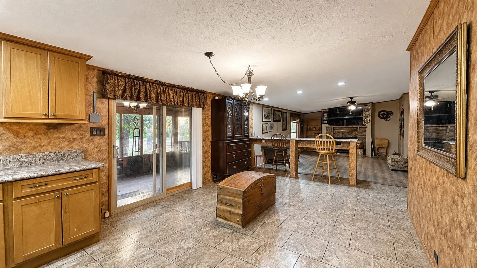 Dining Area with Sliding Glass Door to Screened-in Back Patio in Double-Wide Home.