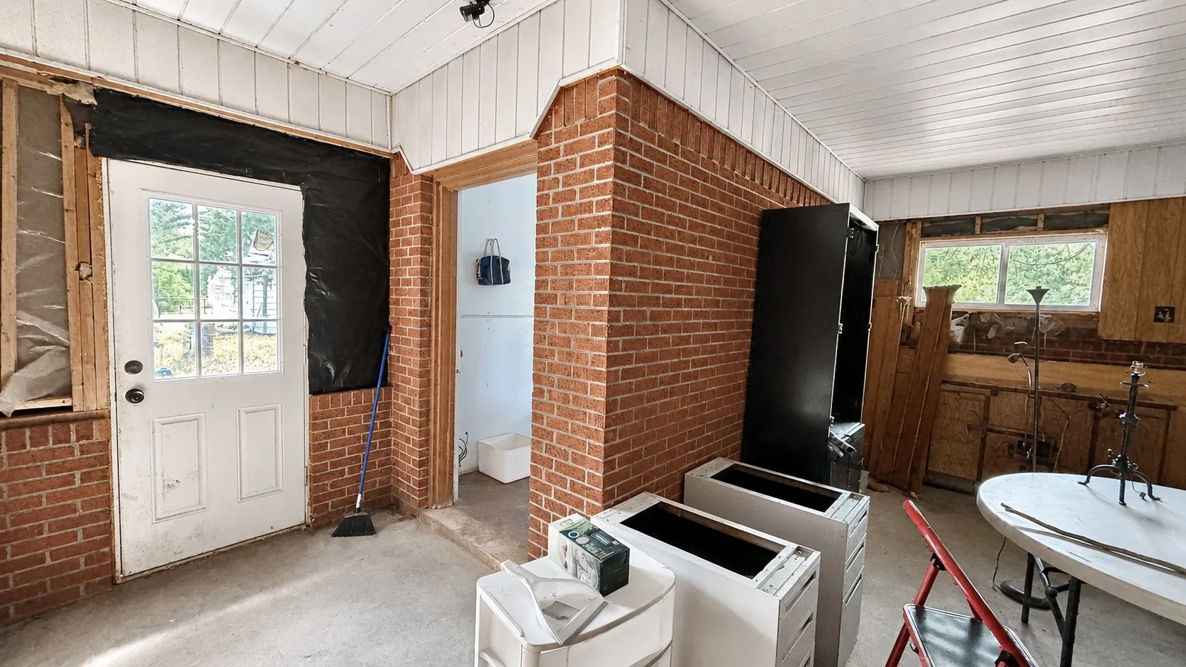Laundry Room in the Enclosed Carport Area to the Red Brick Home.