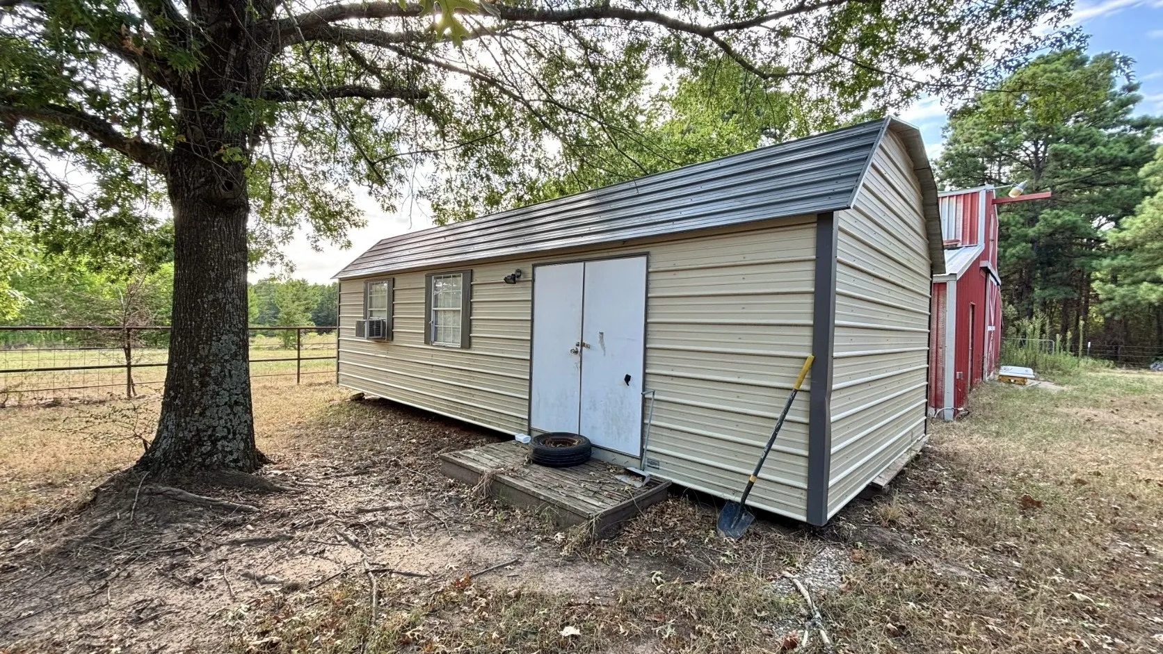 14'x30' Outbuilding Next to Red Barn Behind Red Brick Home.