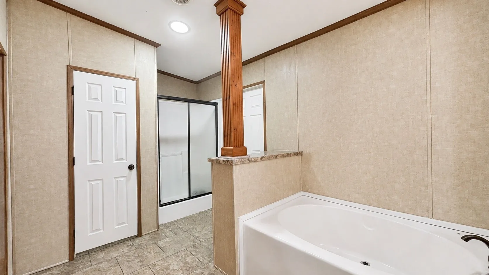 Primary Bathroom Toilet Area and Separate Walk-In Shower in Double-Wide Home.