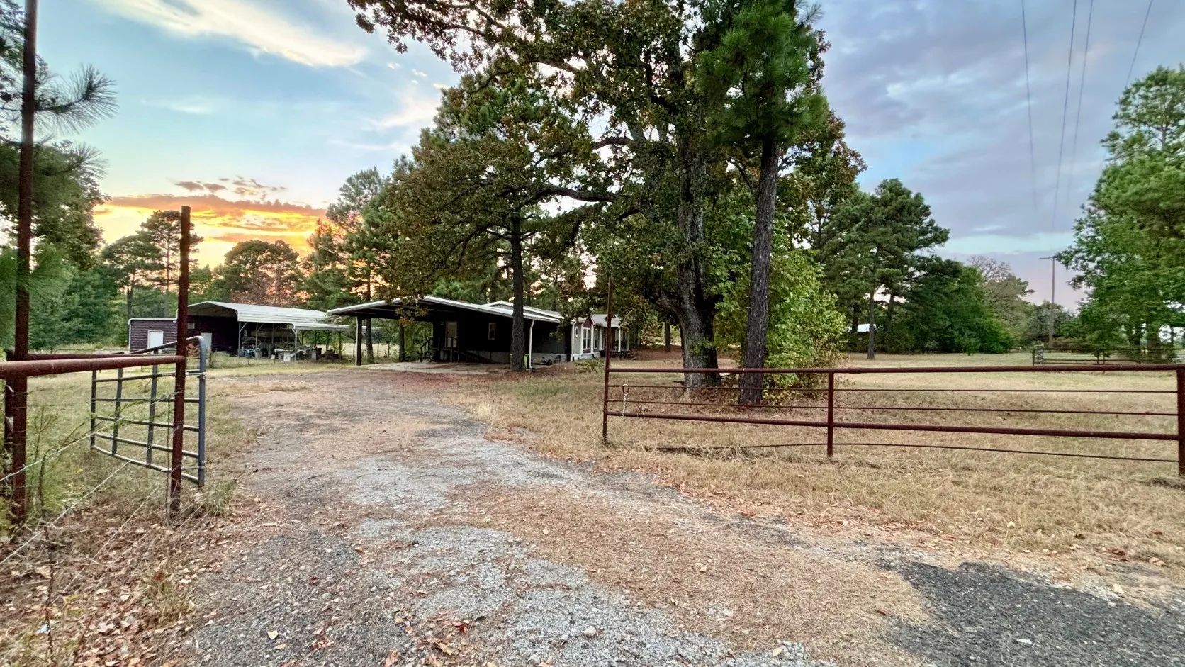 Pipe Fence Entry and Gate to Double-Wide Home.