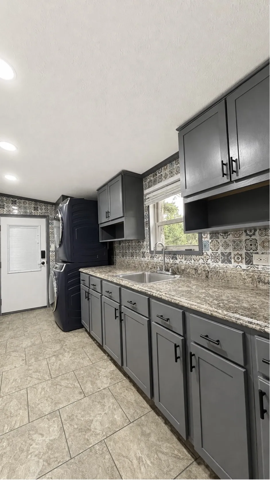 Laundry Room with Side Door that Leads to Carport in the Double-Wide Home.