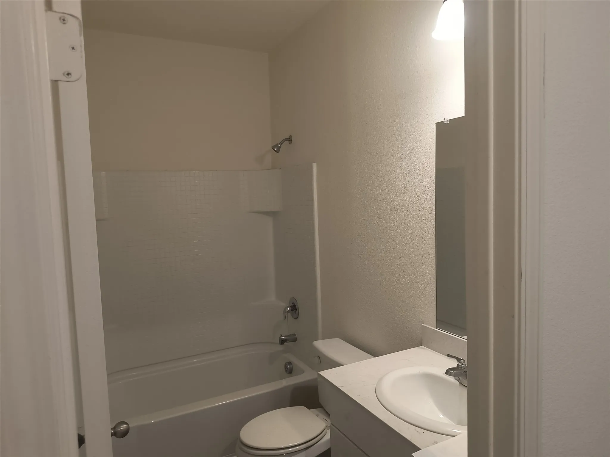 White wall-mounted vanity with a porcelain sink and chrome faucet