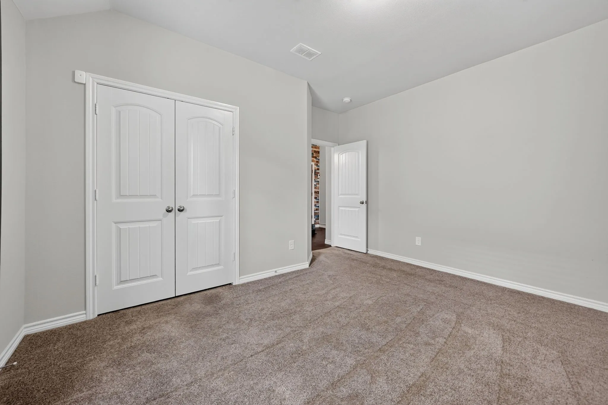 Neutral-toned carpeting, light gray wall finishes, and white trim