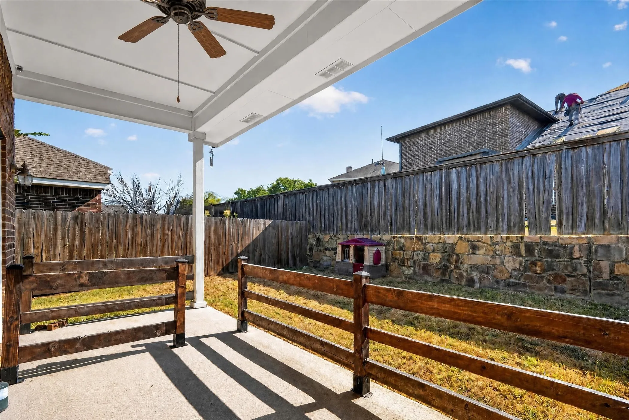 Covered patio featuring a ceiling fan and concrete flooring
